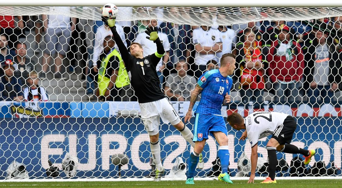 Goalkeeper Manuel Neuer of Germany tips the ball over the bar after a shot by Juraj Kucka of Slovakia. 