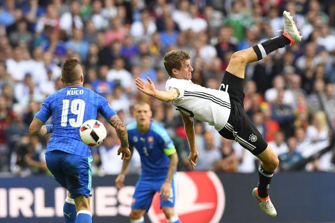Germany's midfielder Thomas Mueller, right, challenges Slovakia's midfielder Juraj Kucka.