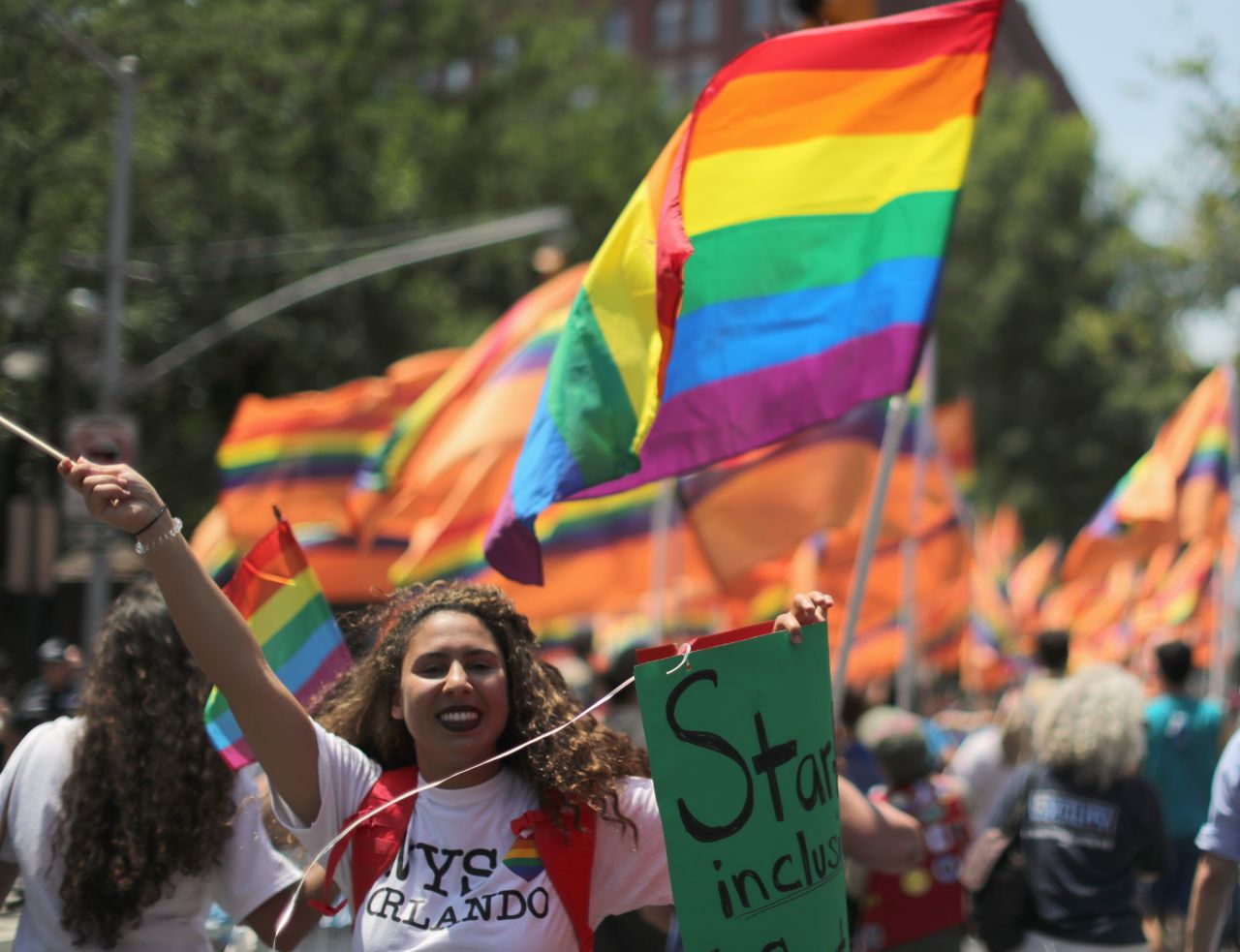 Marchers carry rainbow flags and signs in tribute to the Orlando shooting victims during New York's parade on June 26. 