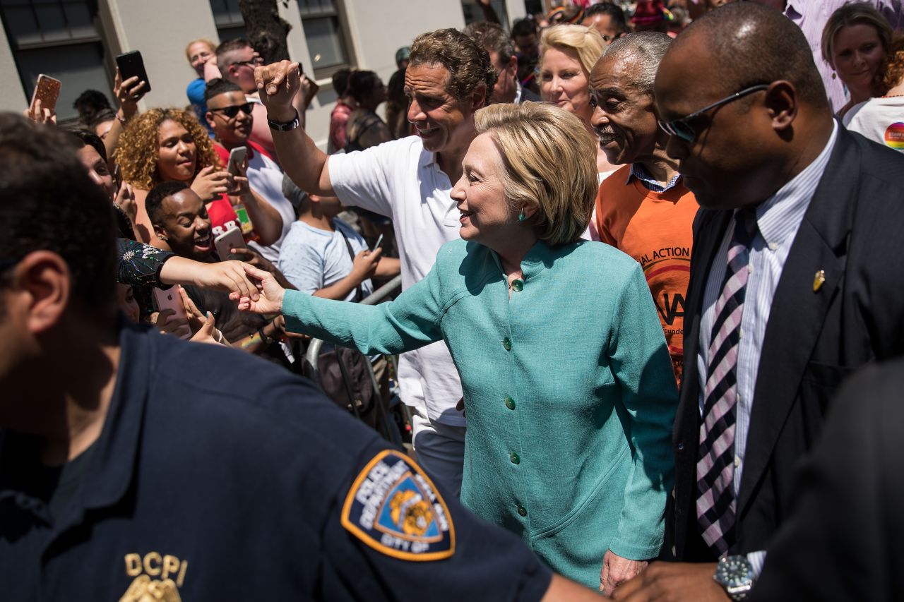 Democratic presidential candidate Hillary Clinton, flanked by New York Governor Andrew Cuomo and Rev. Al Sharpton, attends New York's parade on June 26. 