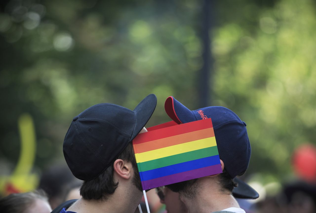 Men cover their faces with rainbow flags during a gay pride parade in Bucharest, Romania, on Saturday. Homosexuality was a crime in communist-era Romania, and it is still not widely accepted among many Romanian people. Many gays hide their sexual orientation to avoid discrimination. 