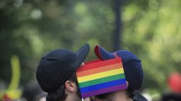 Men cover their faces with rainbow flags during a gay pride parade in Bucharest, Romania, Saturday, June 25, 2016. During the years of communist rule, before 1989, homosexuality was a crime, and it is still not widely accepted among many Romanian people, with many gays avoiding to disclose their sexual orientation to avoid discrimination. (AP Photo/Vadim Ghirda)