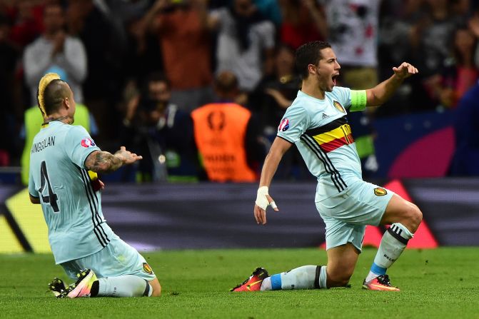 Belgian forward Eden Hazard, right, celebrates after scoring his team's third goal.