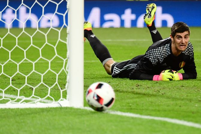 Belgian goalkeeper Thibaut Courtois reacts as he dives for the ball.