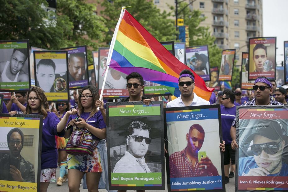 Participants in the 47th annual Chicago Pride Parade carry pictures of the Orlando shooting victims.