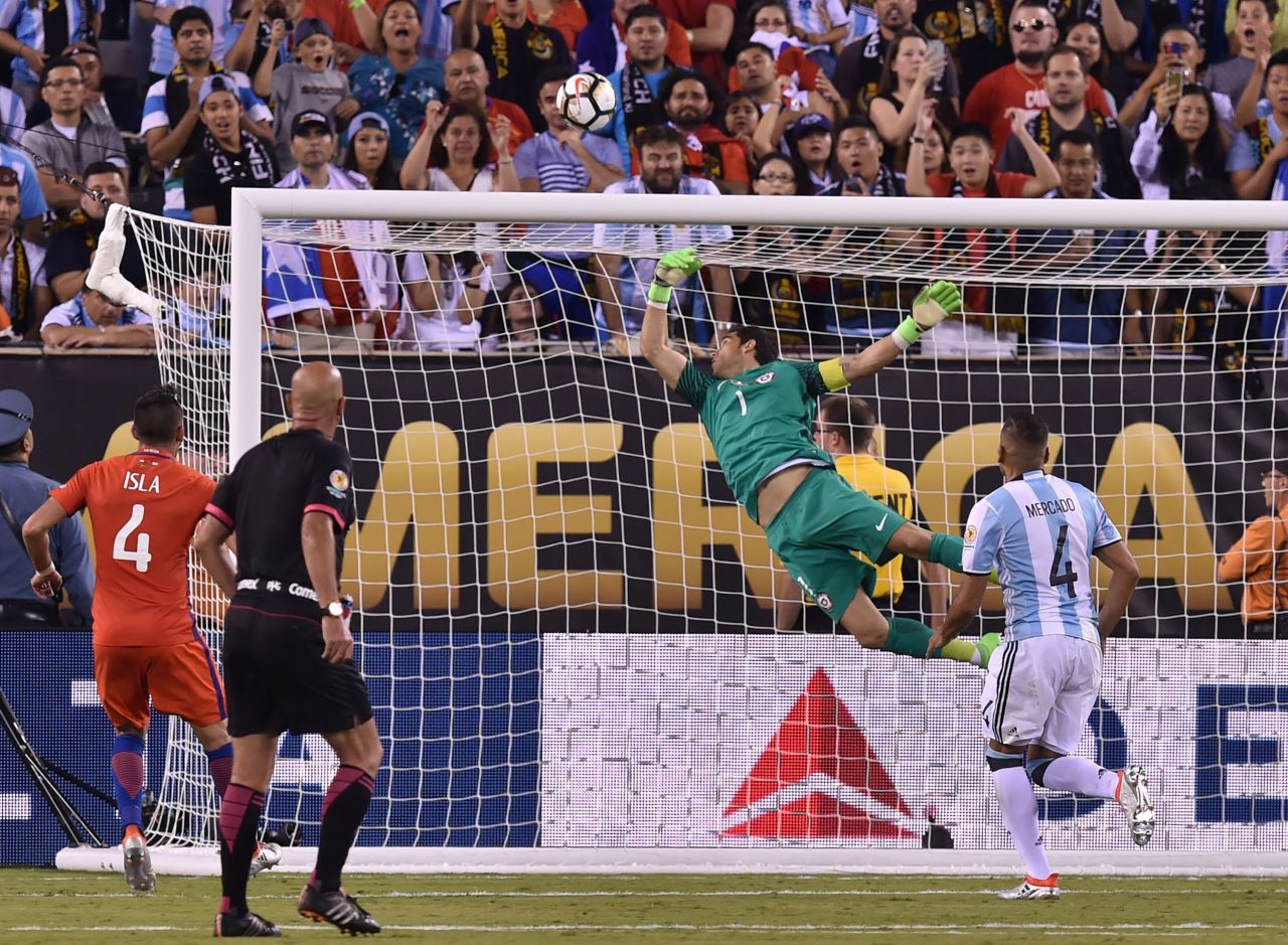 Chile's goalkeeper Claudio Bravo pulls off a save following a header by Argentina's Sergio Aguero (out of frame).