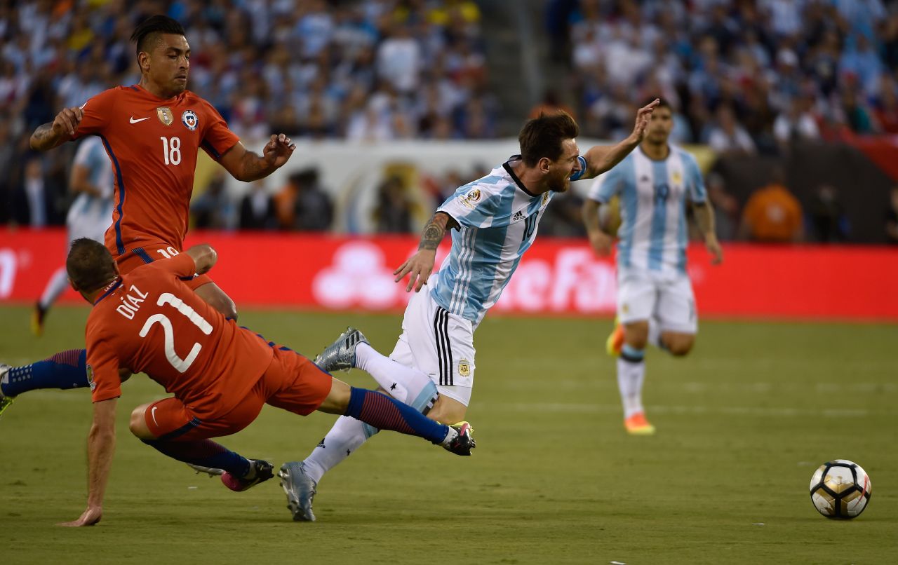 Argentina's Lionel Messi, right,  is fouled by Chile's Marcelo Diaz.