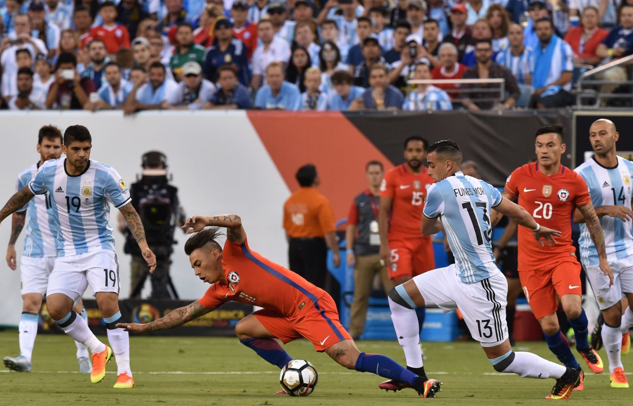 Chile's Eduardo Vargas is fouled by Argentina's Ramiro Funes Mori.