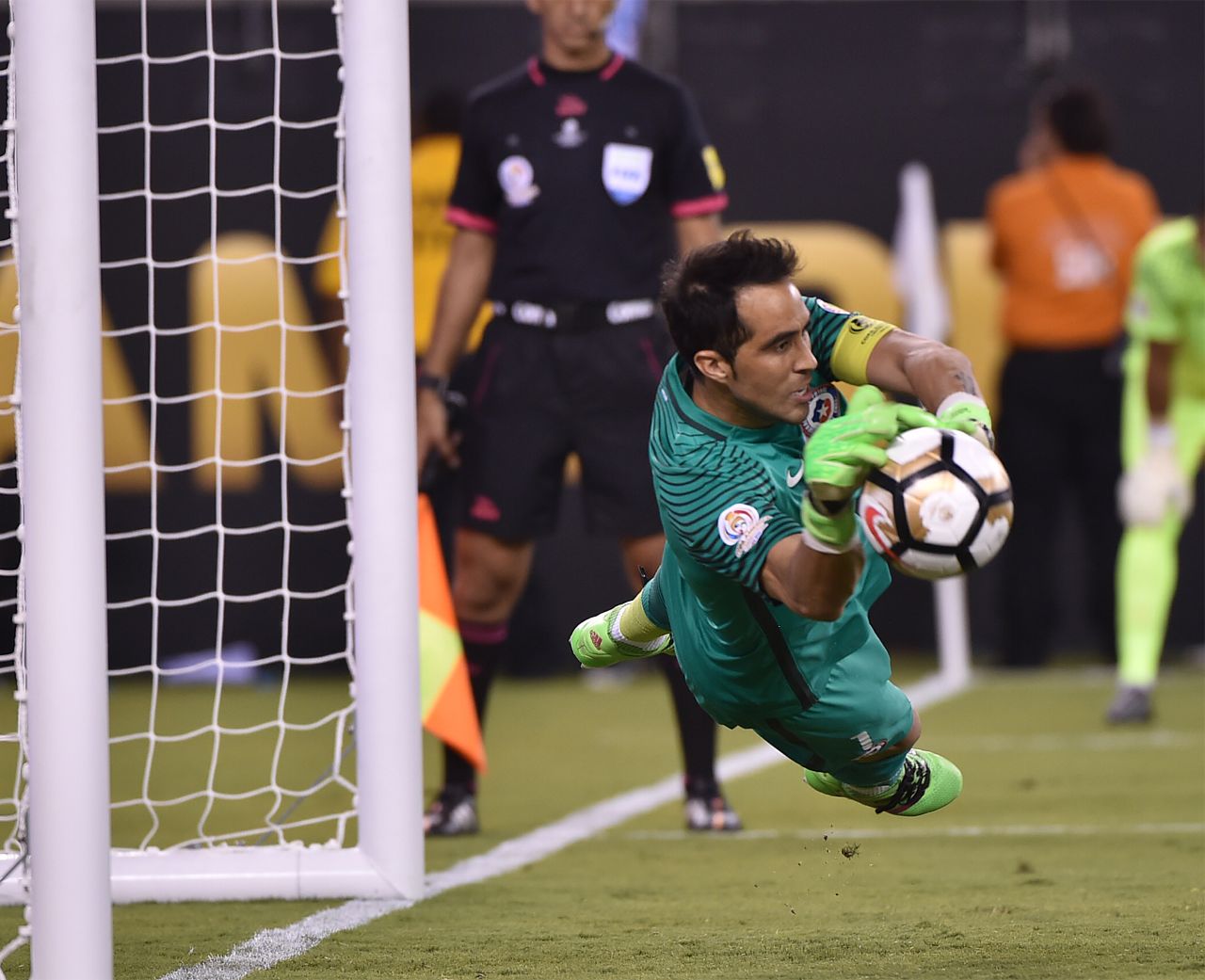 Chile's goalie Claudio Bravo stops a shot by Argentina's Lucas Biglia (out of frame).