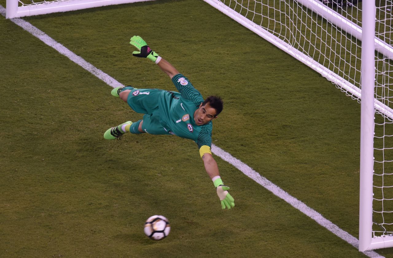 Chile's goalie Claudio Bravo fails to stop a shot by Argentina's Sergio Aguero, out of frame, during the penalty shoot-out.