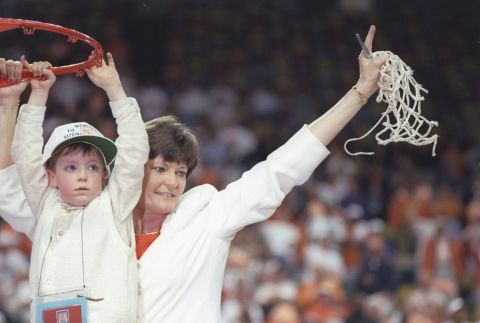 Tennessee Lady Volunteers head coach Pat Summitt cuts down the net with help of her son Tyler after winning the national championship in March 1997.