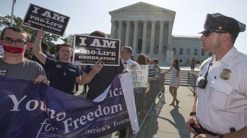 Activists demonstrate in front of the Supreme Court in Washington, Monday, June 27, 2016, as the justices close out the term with decisions on abortion, guns, and public corruption are expected.