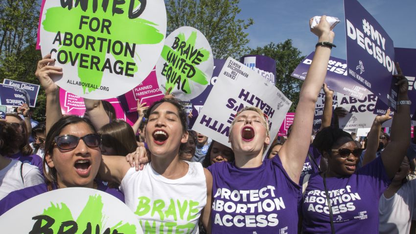 Abortion rights activists, from left, Ravina Daphtary of Philadelphia, Morgan Hopkins of Boston, and Alison Turkos of New York City, rejoice in front of the Supreme Court in Washington, Monday, June 27, 2016, as the justices struck down the strict Texas anti-abortion restriction law known as HB2. Other cases are to follow on guns, and public corruption.