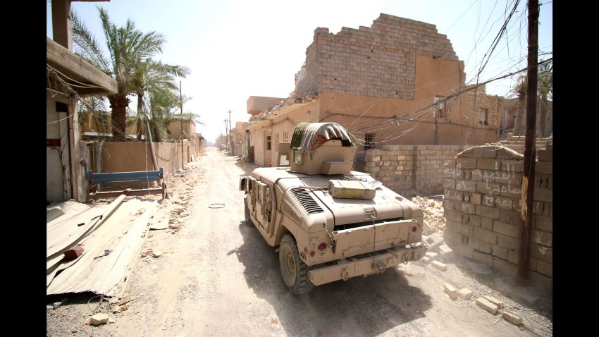 Iraqi government forces drive their armored vehicle through a street in western Falluja, Iraq, on Monday, June 27, after retaking the city from ISIS.