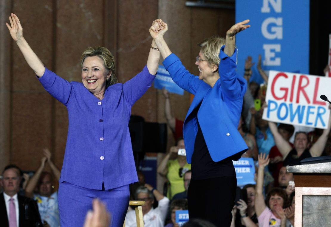 Hillary Clinton and U.S. Sen Elizabeth Warren wave to the crowd before a campaign rally on June 27, 2016 in Cincinnati, Ohio.