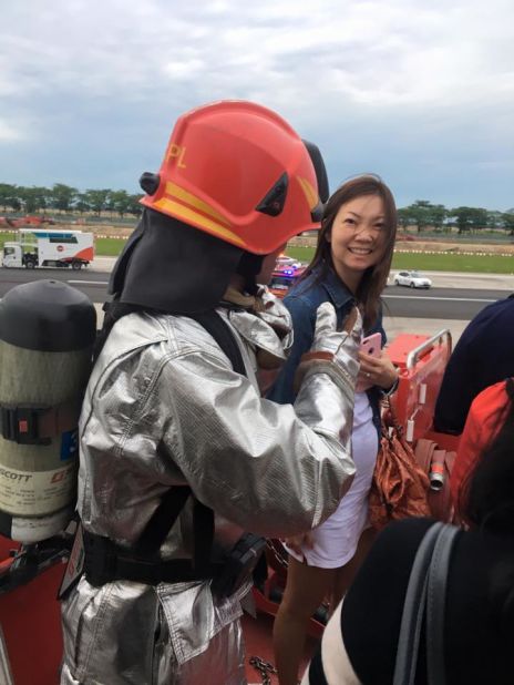 Lee thanks a firefighter as she disembarks the plane. 