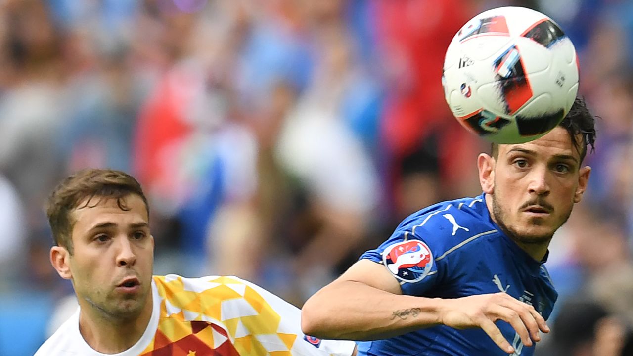 Spanish midfielder Koke, left, eyes the ball next to Italy's Alessandro Florenzi.