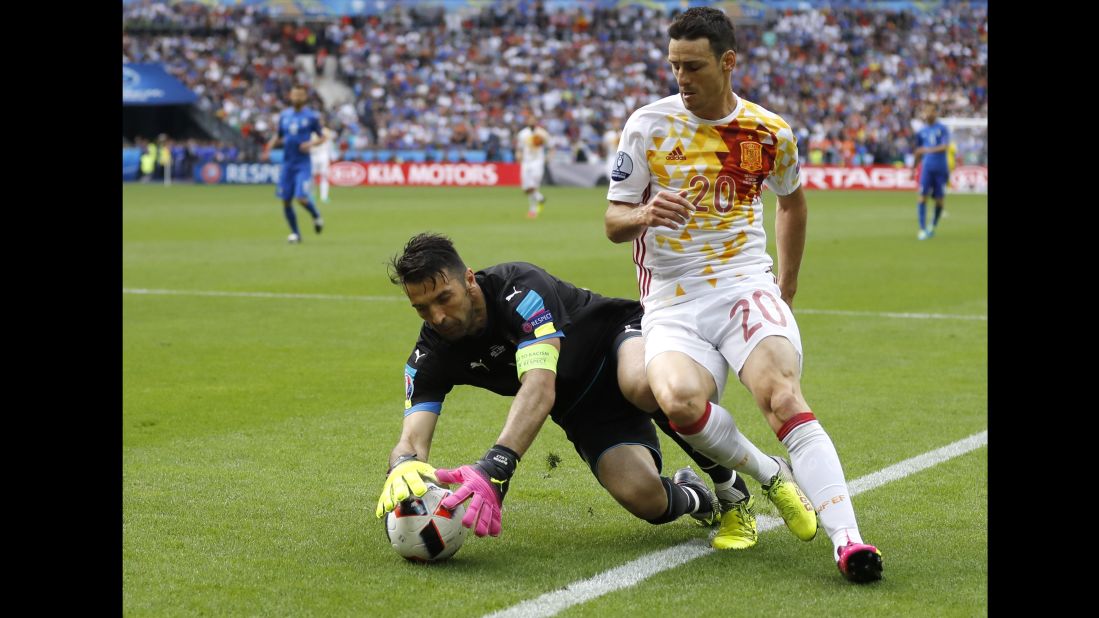 Italian goalkeeper Gianluigi Buffon snatches a ball away from Spain's Aritz Aduriz.