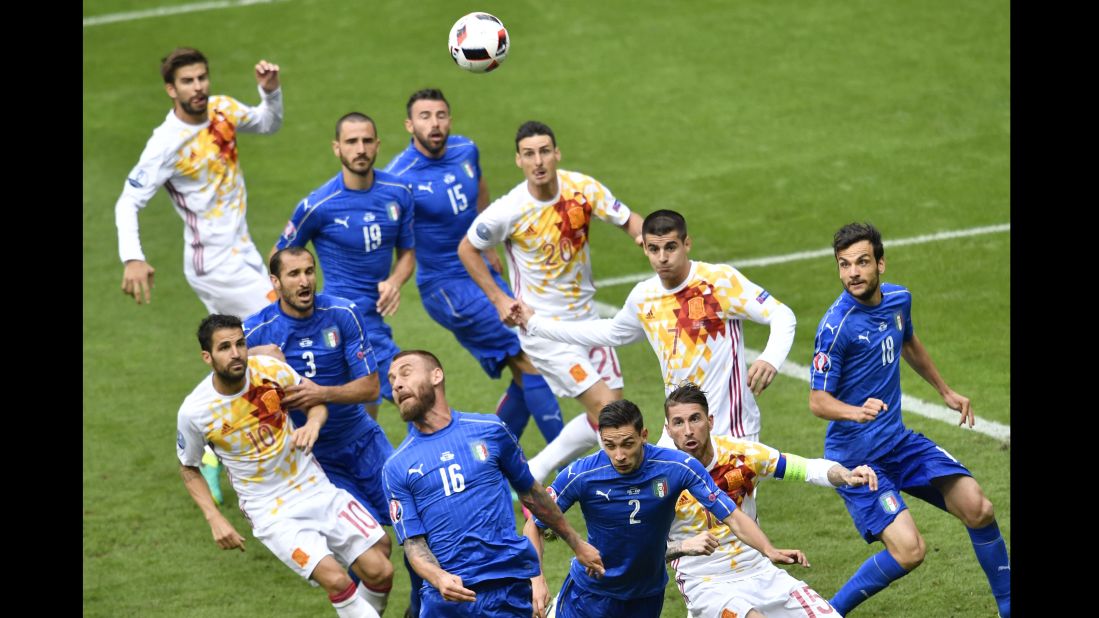 Italian midfielder Daniele De Rossi (No. 16)heads the ball in the box.