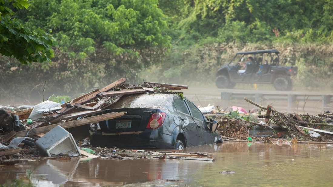 A car sits in floodwaters in Jordan Creek, West Virginia, on June 26.