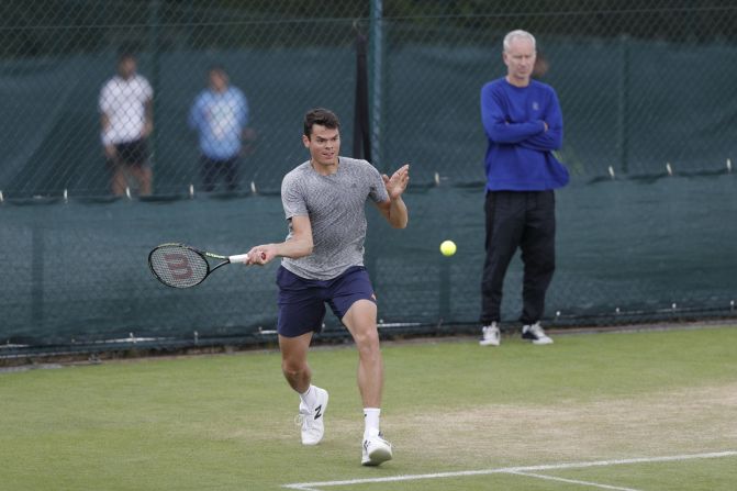 Tennis legend John McEnroe looks on as Canadian sixth seed Milos Raonic, who he is now coaching, warms up ahead of a straight-sets victory over Spaniard Pablo Carre?o Busta.