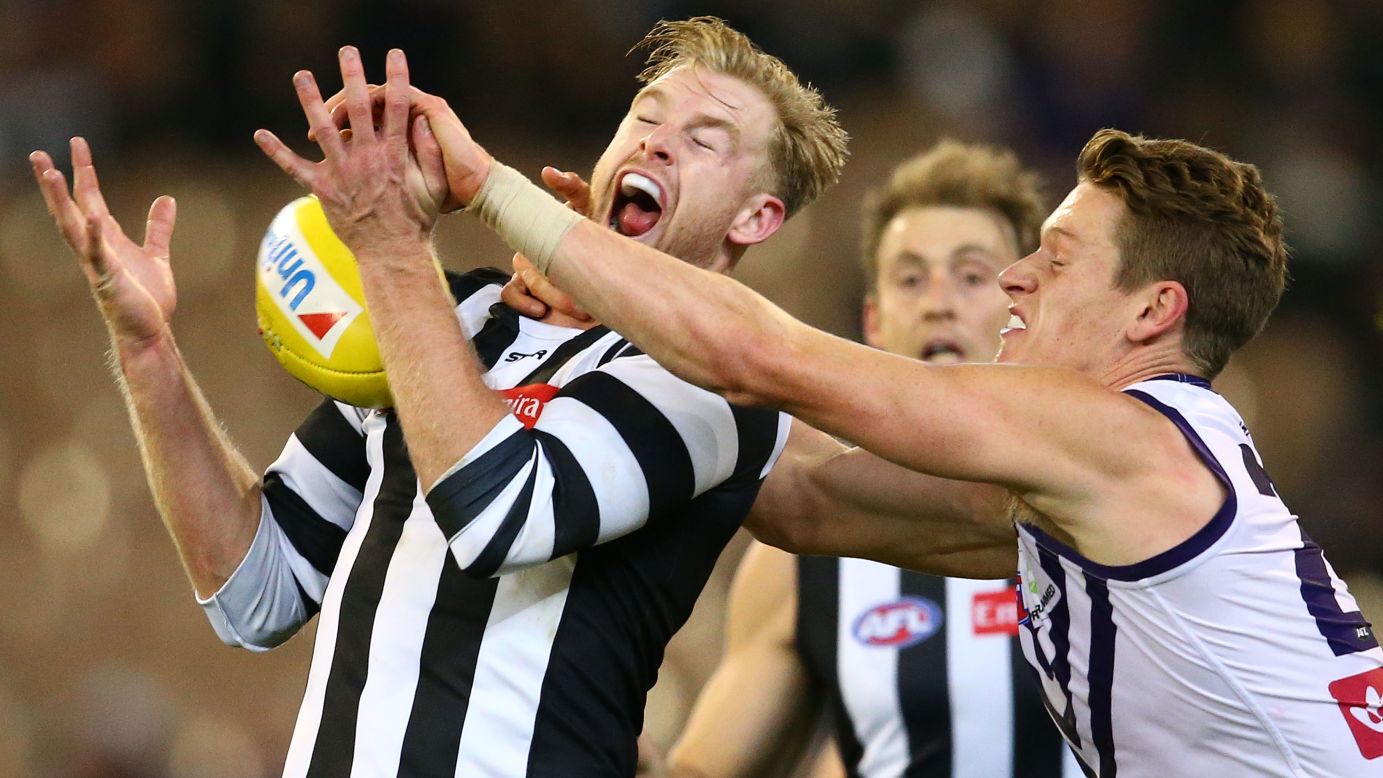 Jonathon Marsh of the Collingwood Magpies, left, and Matt Taberner of the Fremantle Dockers compete for the ball during an Australian Football League match in Melbourne on Friday, June 24.