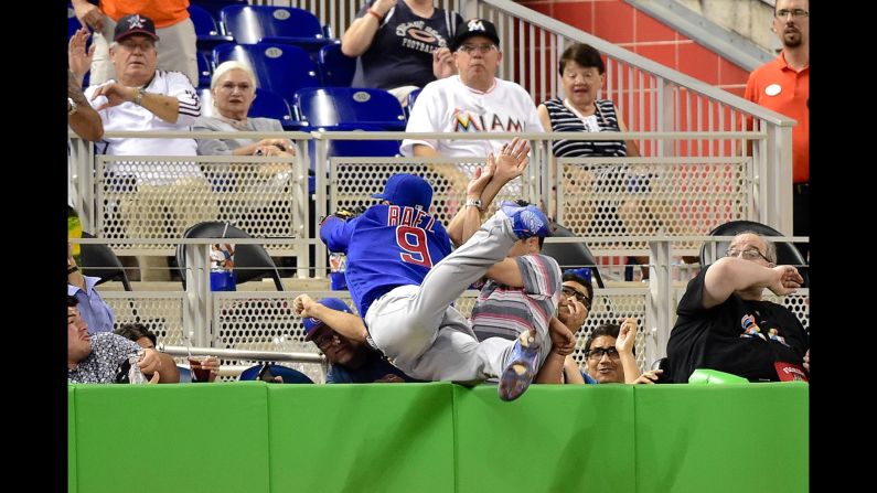 Javier Baez, third baseman for the Chicago Cubs, makes a diving catch in foul territory during a game in Miami on Friday, June 24.