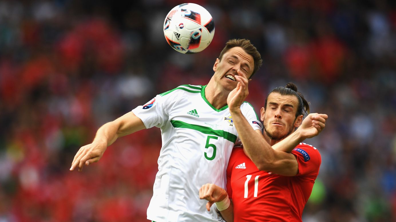 Northern Ireland's Jonny Evans, left, competes for a header with Wales' Gareth Bale during a match in Paris on Saturday, June 25. Wales won 1-0 to advance to the quarterfinals of Euro 2016.