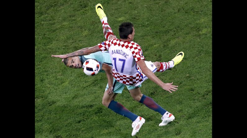 Portugal's Pepe, left, collides with Croatia's Mario Mandzukic during their round-of-16 match at Euro 2016. Portugal advanced with a 1-0 victory in extra time.