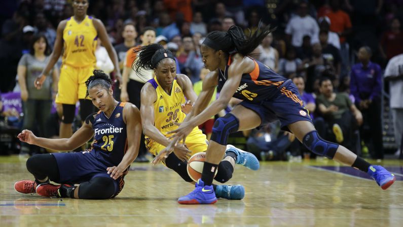 Connecticut's Alyssa Thomas, left, and Chiney Ogwumike try to keep a loose ball away from Nneka Ogwumike during a WNBA game in Los Angeles on Sunday, June 26. Chiney and Nneka are sisters.