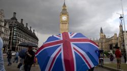 TOPSHOT - A pedestrian shelters from the rain beneath a Union flag themed umbrella as they walk near the Big Ben clock face and the Elizabeth Tower at the Houses of Parliament in central London on June 25, 2016, following the pro-Brexit result of the UK's EU referendum vote.
The result of Britain's June 23 referendum vote to leave the European Union (EU) has pitted parents against children, cities against rural areas, north against south and university graduates against those with fewer qualifications. London, Scotland and Northern Ireland voted to remain in the EU but Wales and large swathes of England, particularly former industrial hubs in the north with many disaffected workers, backed a Brexit. / AFP / JUSTIN TALLIS        (Photo credit should read JUSTIN TALLIS/AFP/Getty Images)