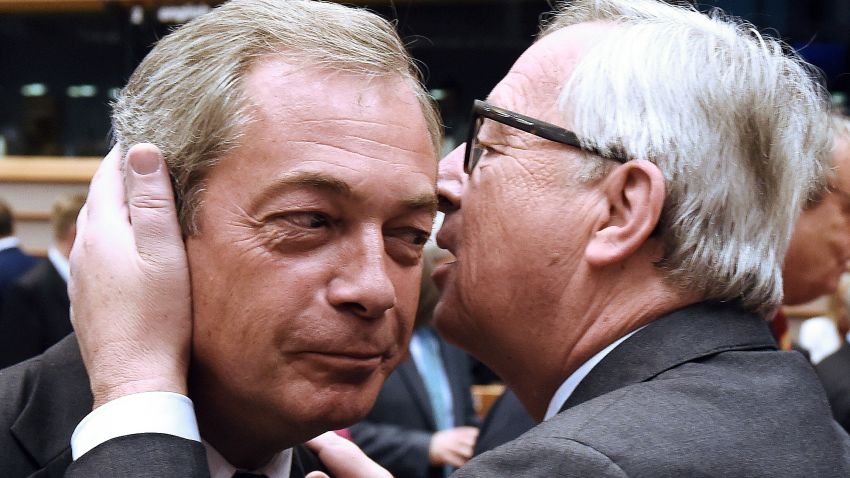 UK Independence Party (UKIP) leader Nigel Farage, left, talks with EU Commission President Jean-Claude Juncker before a plenary session at the EU headquarters in Brussels on Tuesday, June 28. European Commission chief Jean-Claude Juncker called on Prime Minister David Cameron to clarify when Britain intends to leave the EU, saying there can be no negotiation on future ties before London formally applies to exit.