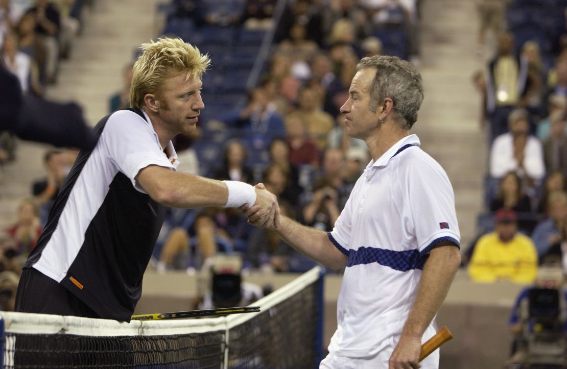 Boris Becker shakes hands with John McEnroe before playing an exhibition match during the US Open in 2002. 
