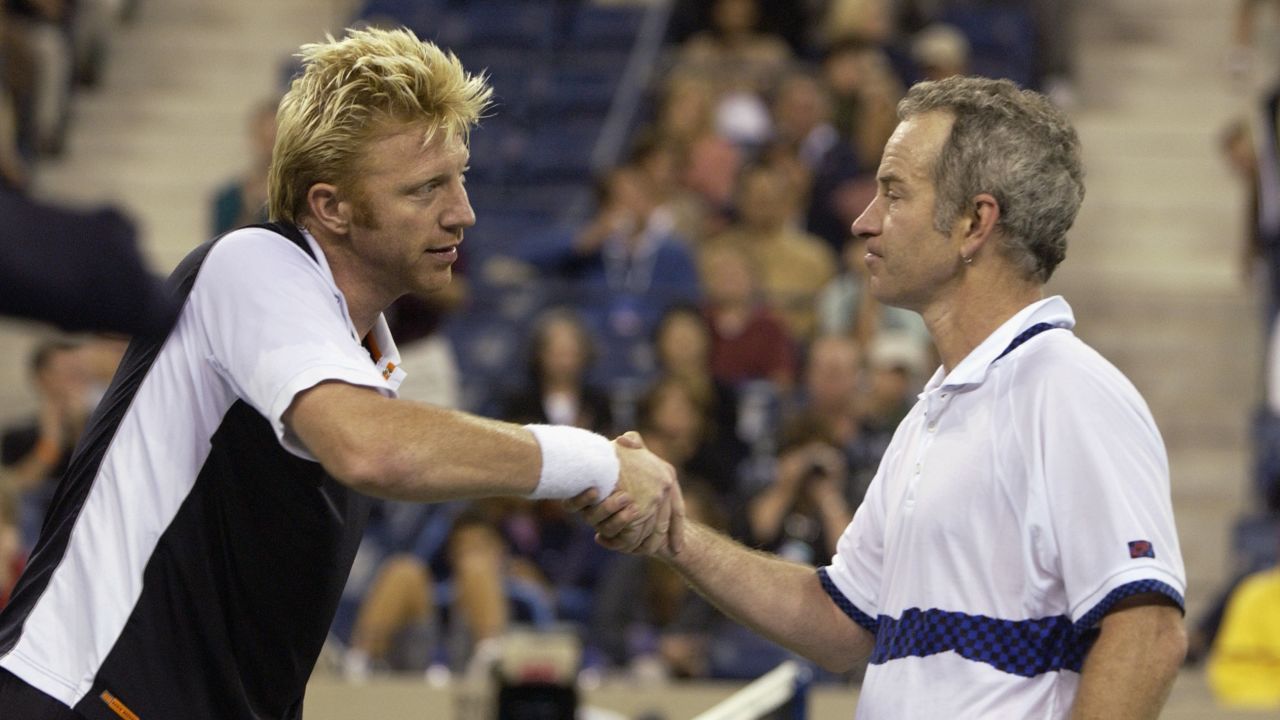Boris Becker shakes hands with John McEnroe before playing an exhibition match during the US Open in 2002. 