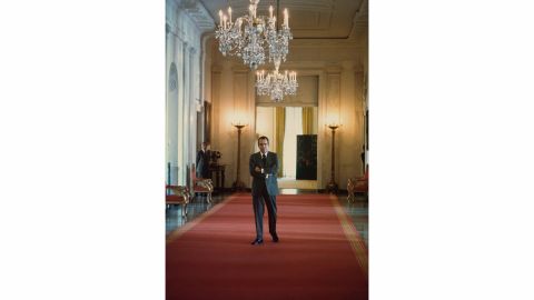 U.S. President Richard Nixon waits to enter the East Room of the White House for an event in 1974. A few weeks later, the Watergate scandal would drive him from office.