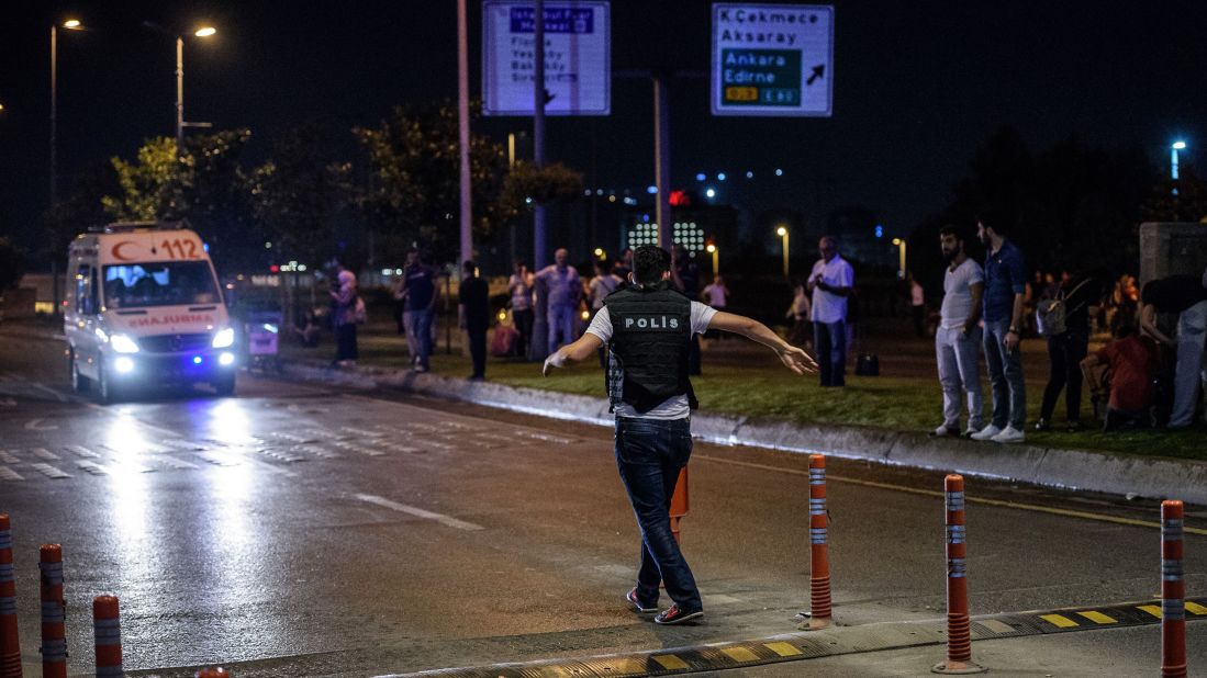 A police officer sets up a security perimeter.