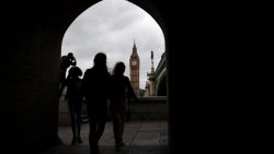 Pedestrians walk along the South Bank opposite the Big Ben clock face and the Elizabeth Tower at Houses of Parliament in central London on June 29, 2016.