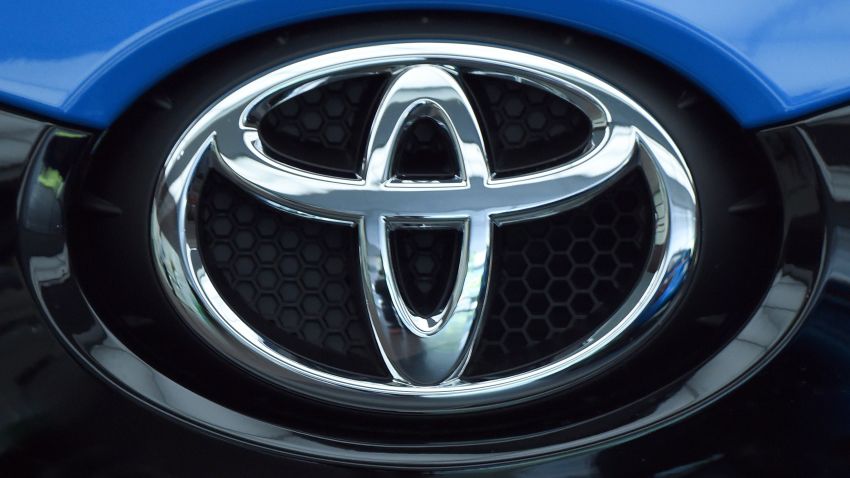 The Toyota logo on the front of one of their vehicles.