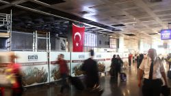  Passengers walk in the damaged parts of the international terminal of the country's largest airport, Istanbul Ataturk, following yesterday's blast on June 29, 2016 in Istanbul, Turkey. 