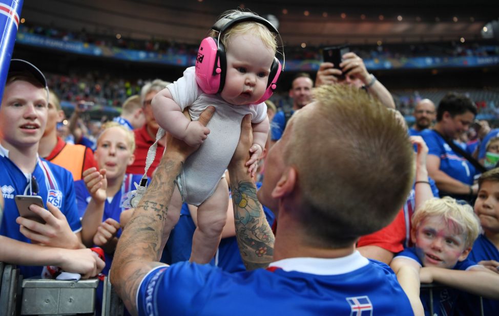 Ari Skulason of Iceland celebrated with his baby while his teammates sought out family members inside the stadium. Around 8% of the country's population is estimated to have traveled to France for the finals.