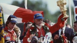 Niki Lauda of Austria and driver of the #8 Marlboro McLaren International McLaren MP4B Ford Cosworth DFV V8 lifts the RAC Trophy and celebrates with second placed Didier Pironi after winning the Marlboro British Grand Prix on 18 July 1982 at the Brands Hatch circuit in Fawkham, Great Britain. (Photo by Adrian Murrell/Getty Images) 