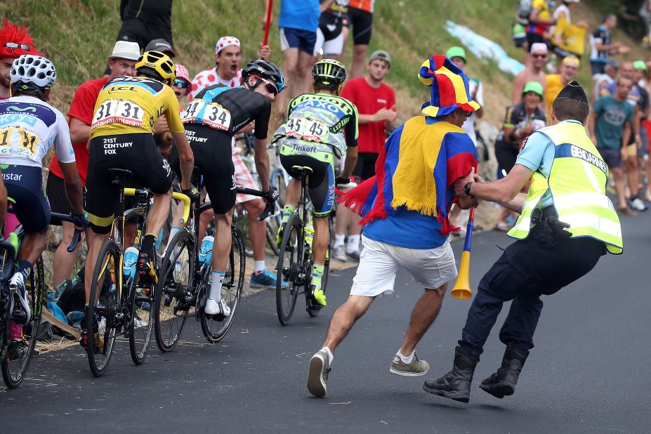 Over enthusiastic fans can pose a risk to riders and here a Colombian supporter is pulled aside by a gendarme during the 2015 race won by Froome.