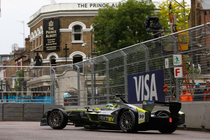 Last year's championship winner, leader Nelson Piquet of Brazil, takes his car around a corner near a pub on the borders of the Battersea circuit.