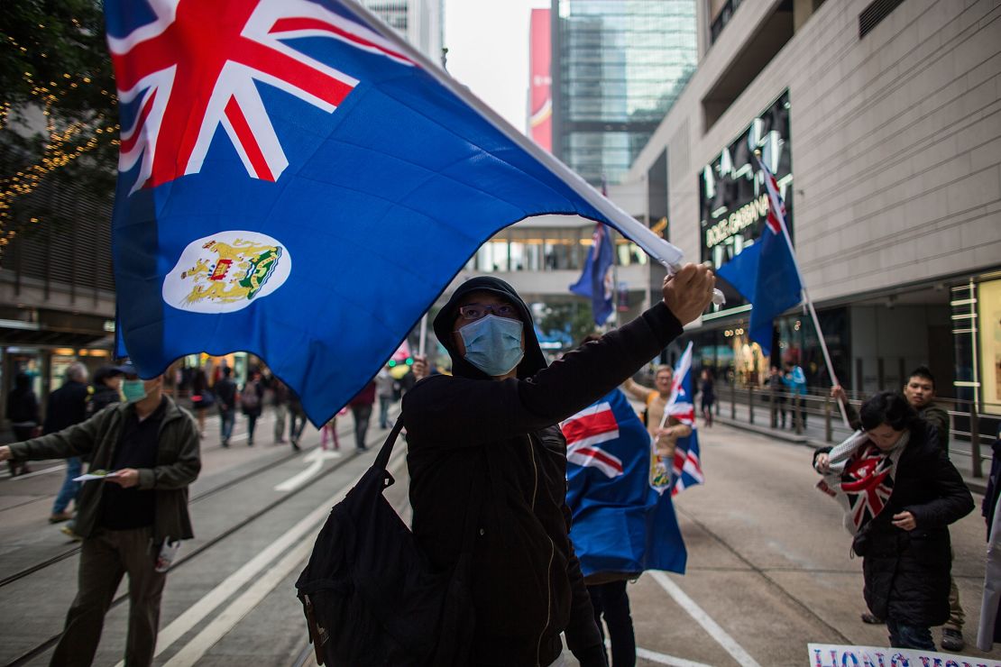 Pro-democracy protesters wave the flag of colonial Hong Kong during a march for democracy on February 1, 2015.