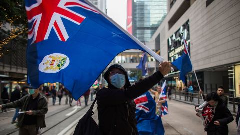 Pro-democracy protesters wave the flag of colonial Hong Kong during a march for democracy on February 1, 2015.