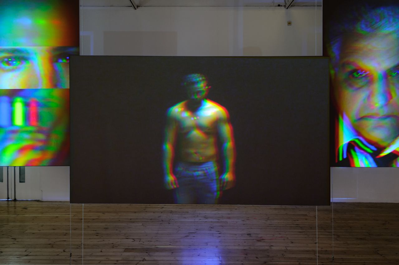 In the five-channel video installation "The Watchers No. 1-5", Al-Maria evokes the male gaze with a reenactment of a dream sequence in the script for "Beretta."<br /><br /><em>Still from "The Watchers No. 1-5'" (2014) by Sophia Al-Maria</em>