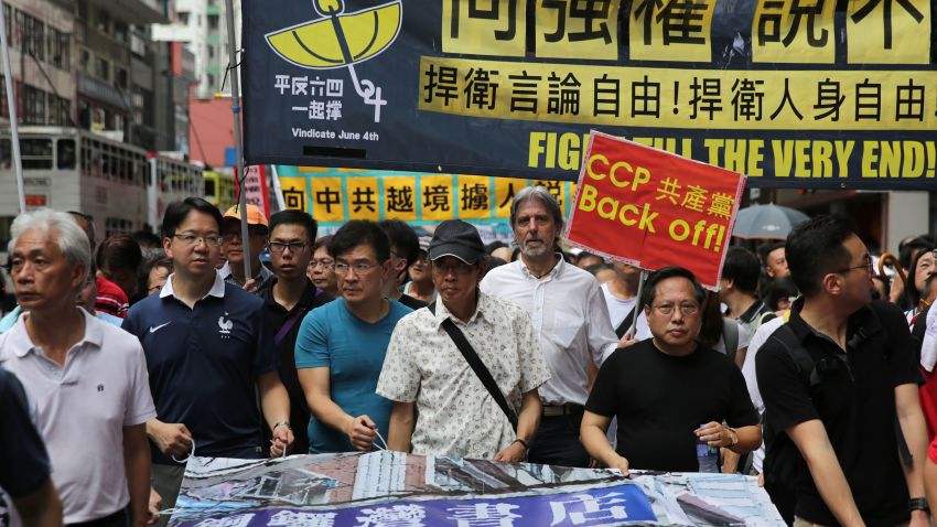Lam Wing-kee (C-in cap), one of five Hong Kong booksellers who went missing last year, leads a protest in Hong Kong on June 18, 2016.
The Hong Kong bookseller who said he was blindfolded, interrogated and detained in China led the protest march on June 18 defying Beijing as pressure grows for authorities to answer questions over the case.  / AFP / ISAAC LAWRENCE        (Photo credit should read ISAAC LAWRENCE/AFP/Getty Images)