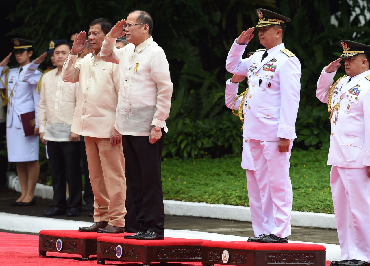 Newly inaugurated <a href="http://www.cnn.com/2016/06/29/asia/philippines-duterte-inauguration/index.html" target="_blank">Philippines president Rodrigo Duterte</a> (center left) stands next to outgoing leader Benigno Aquino (center right), during the departure ceremony for Aquino on June 30, 2016. 