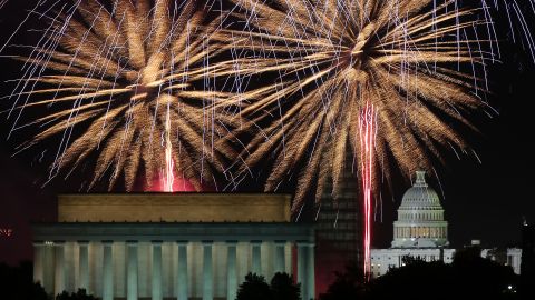 Fireworks light up the sky over the Lincoln Memorial, Washington Monument, and the U.S. Capitol.