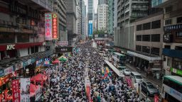 Demonstrators march during a pro-democracy rally seeking greater democracy in Hong Kong on July 1, 2014 as frustration grows over the influence of Beijing on the city.  July 1 is traditionally a day of protest in Hong Kong and also marks the anniversary of the handover from Britain to China in 1997, under a "one country, two systems" agreement. AFP PHOTO / Philippe Lopez        (Photo credit should read PHILIPPE LOPEZ/AFP/Getty Images)